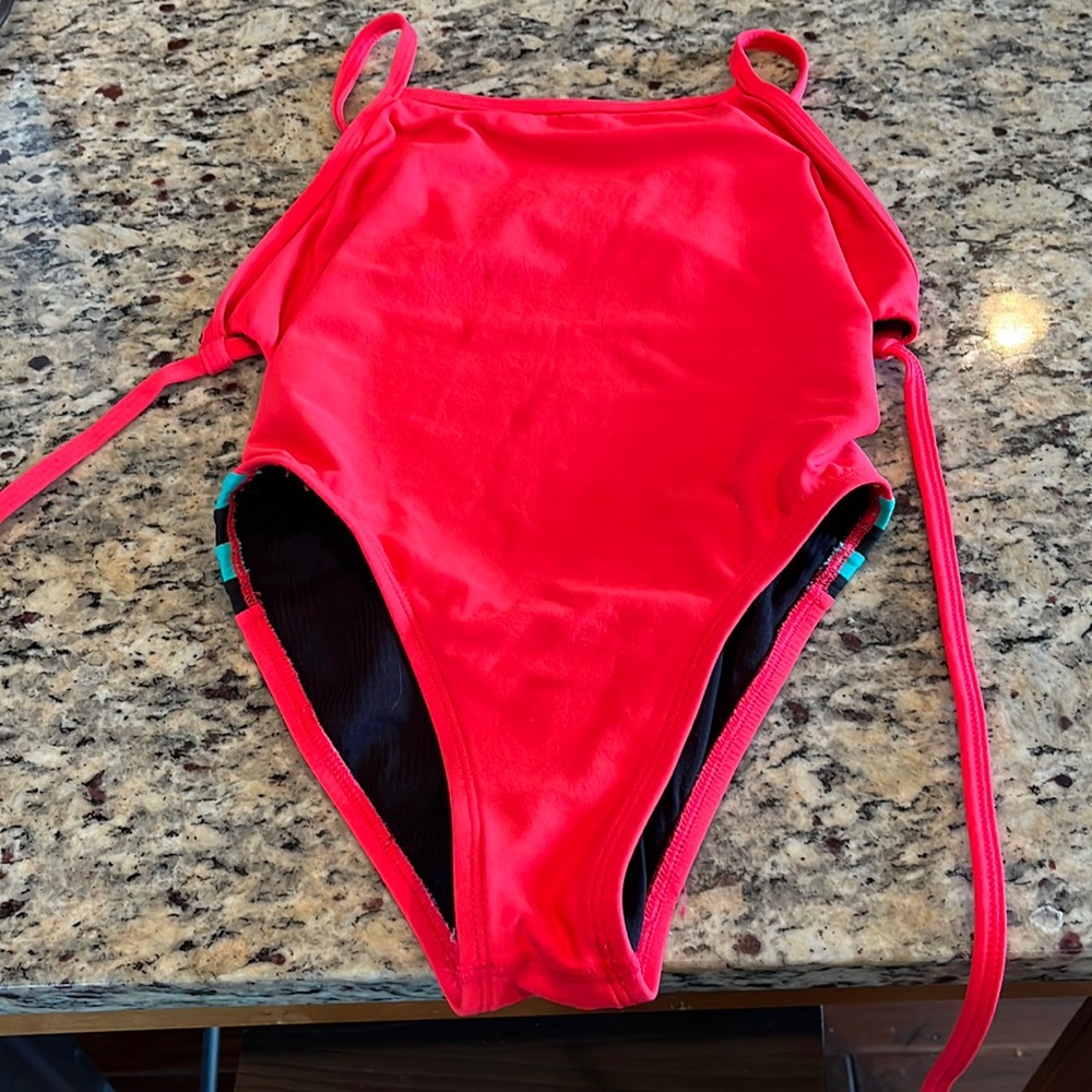 Jolyn One Piece. Tie back suit. Pink with blue and black stripes on the side.